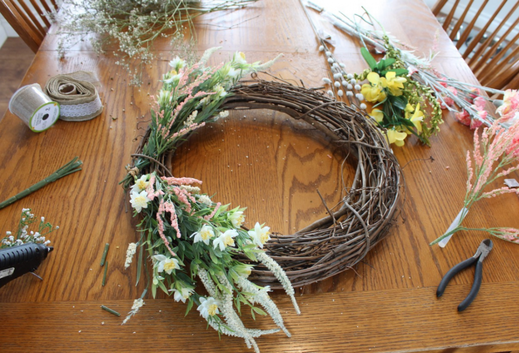 Wreath progress with yellow and coral stems on it