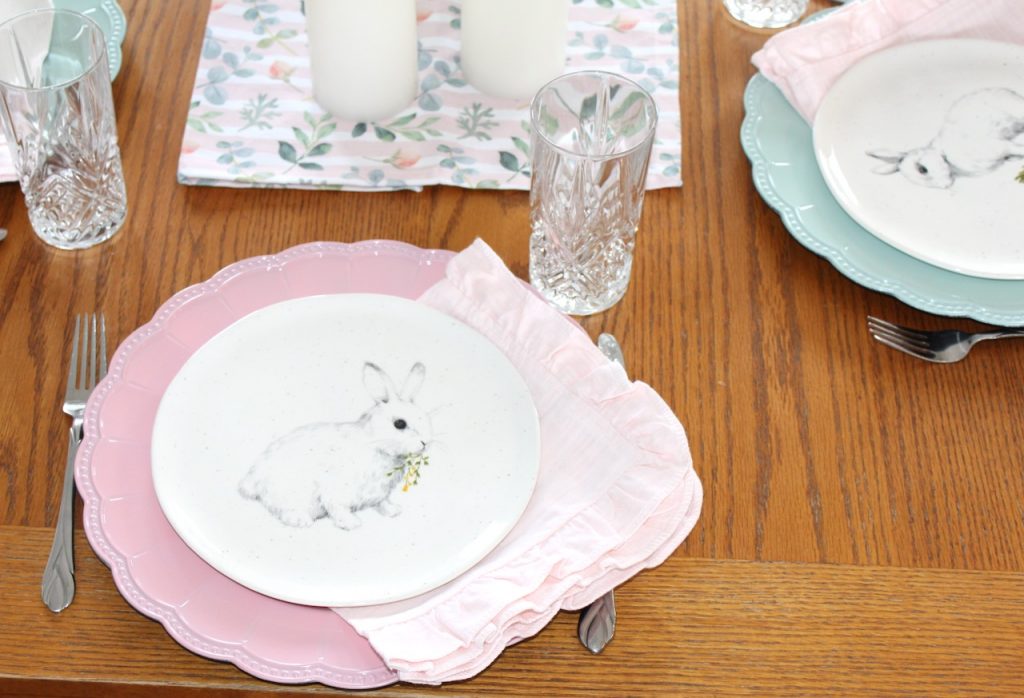 Close up of pink charger with bunny plate and pink napkin