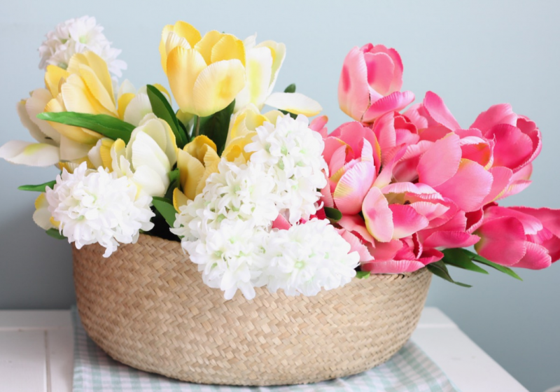 wicker basket filled with flowers as a beautiful way to decorate for spring