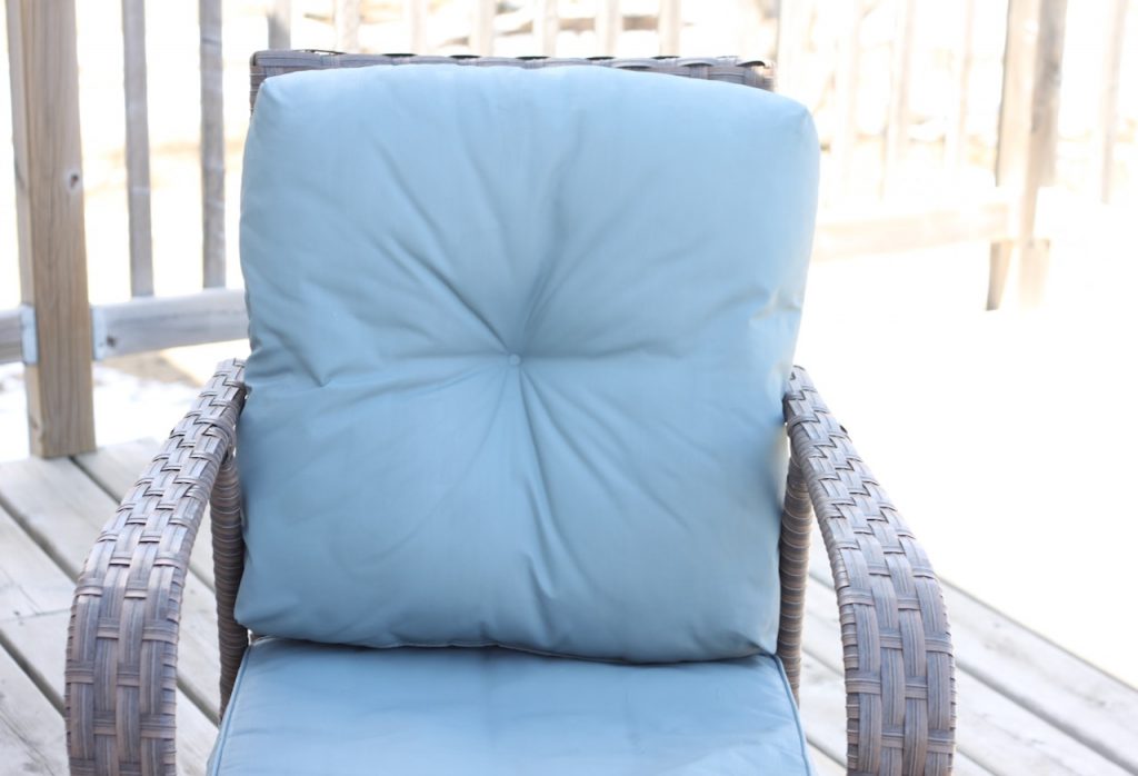 Blue top patio cushion on brown chair