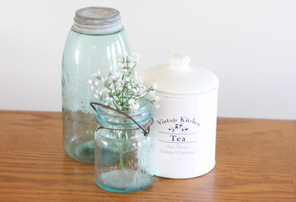 Thrifted blue glass jars with white enamel tea tin to use for home decor