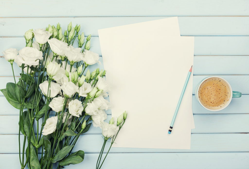 blue shiplap with notebook, pen and flowers