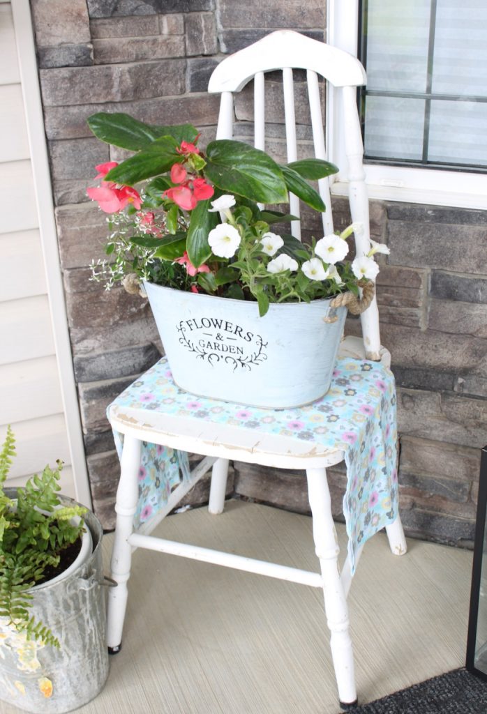 white wood chair with flowers on top
