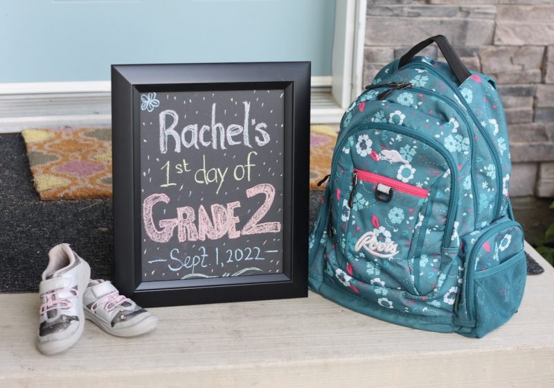 DIY sign sitting beside backpack and shoes