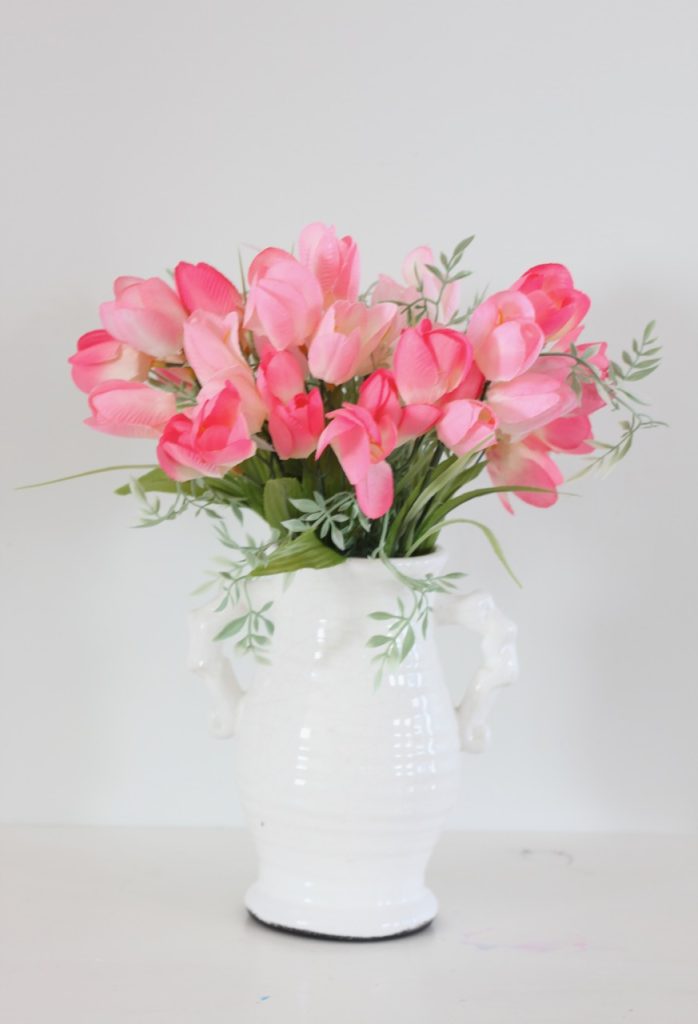 Pink tulips in thrifted white vase